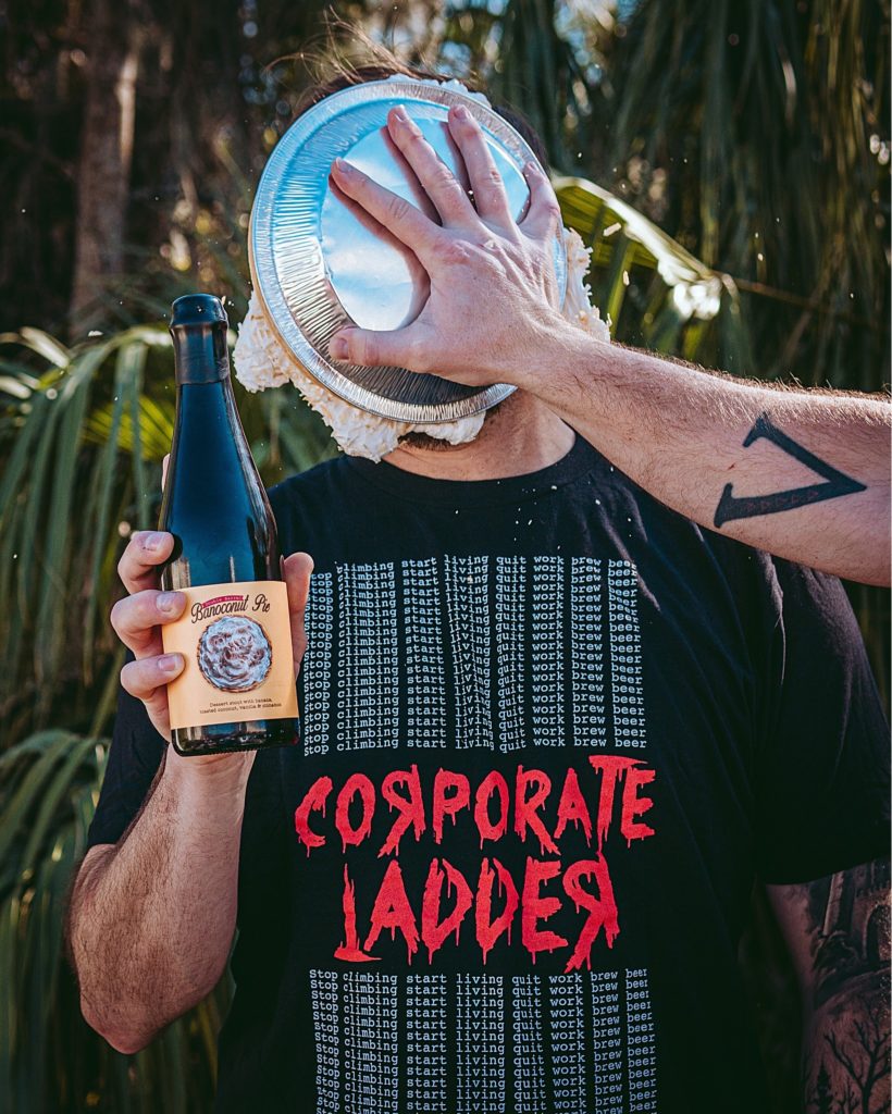 Man getting a pie put in his face. Corporate Ladder Brewing Company. 